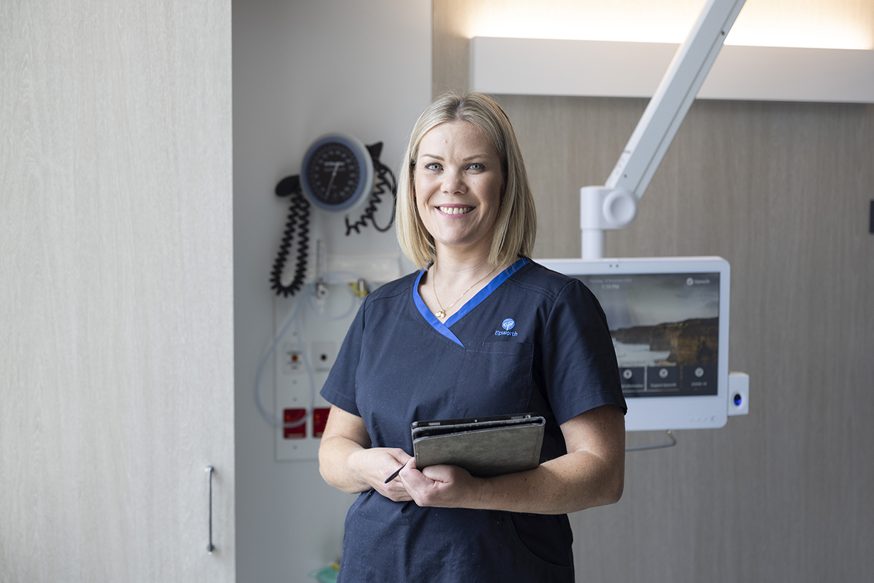 nurse standing in front of machine